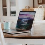 a computer on a table with a web hosting for small business