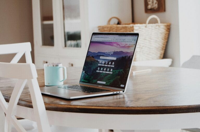 a computer on a table with a web hosting for small business