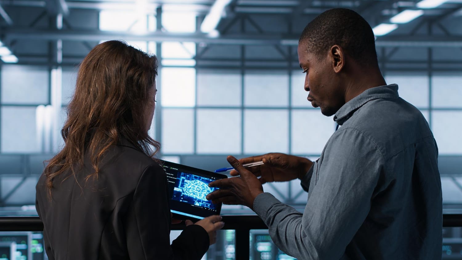 An SEO consultant analyzing an AI network map on a tablet during a strategy briefing.